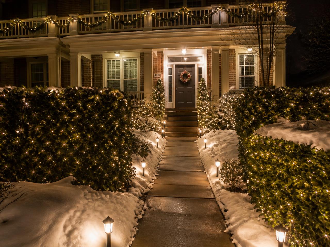 Netted bushes, lit garland on the railings and path lights guiding guests to the door.