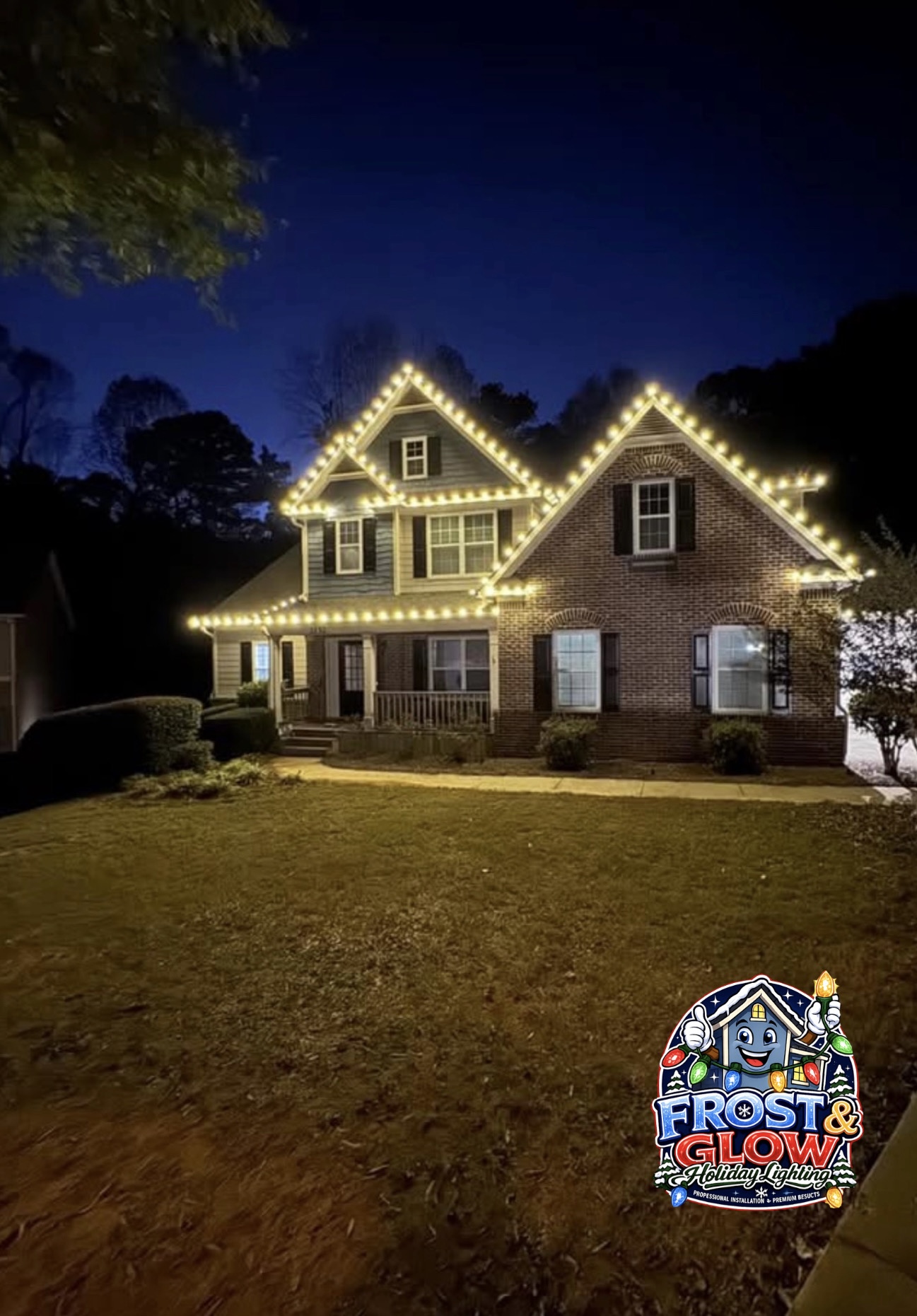 Bright warm-white C9 bulbs define each gable and lower roofline on this two-story brick home.